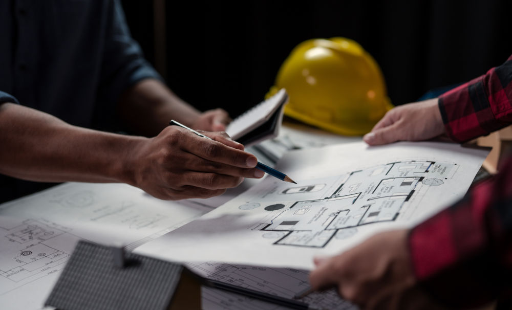 Engineers reviewing floor plans for a fire suppression system quote